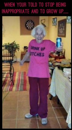 an older woman in pink shirt and purple pants standing on tiled floor next to table