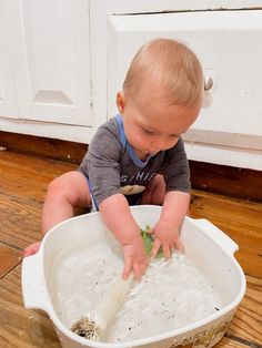 a small child is playing with something in a bowl