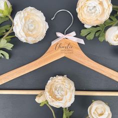 a wooden hanger with flowers on it