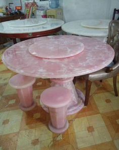 a pink table and chairs in a room