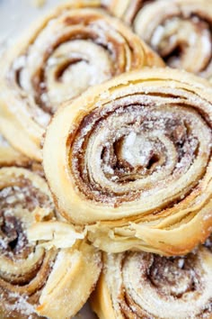 cinnamon rolls are piled on top of each other