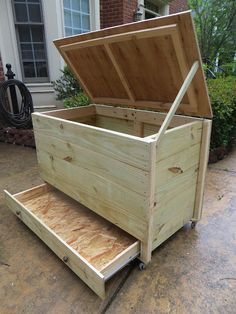 an open wooden box sitting on top of a driveway