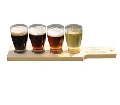 four different types of beer on a wooden tray