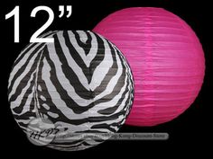 two round paper lanterns with zebra print on them, one pink and the other black