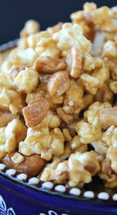 a blue bowl filled with nuts on top of a table