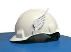 a white hard hat on top of a blue mat