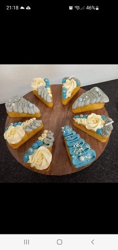 a wooden plate topped with cookies covered in frosting