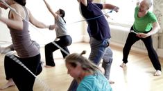 a group of people doing exercises with ropes