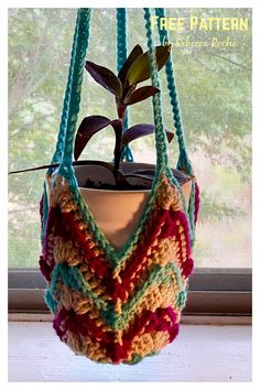 a crocheted pot holder hanging from a window sill with a plant in it