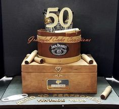 a 50th birthday cake made to look like an old trunk with wine bottles in it