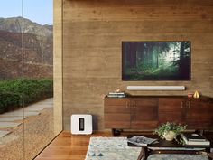 an air purifier sitting on top of a wooden table next to a wall