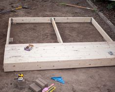 an unfinished bed frame is being built on the ground