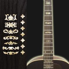 an acoustic guitar with decorative stickers on the top and bottom, next to a black background