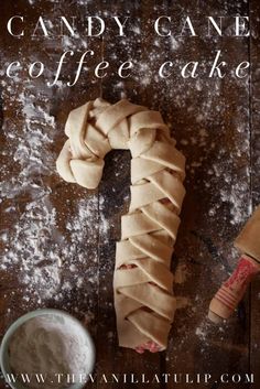 a candy cane coffee cake next to a cup of milk and a knife on a table