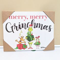 a merry christmas sign on a wooden table