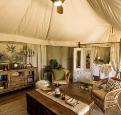 the inside of a tent with furniture and decor