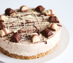 a white plate topped with a cake covered in chocolate and marshmallow toppings