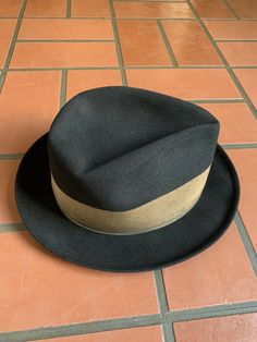 "For your consideration Vintage 60s era CHAMP KASMIR Finish black fedora hat Gold wide grosgrain ribbon 2\" wide Leather sweatband Shows some light dust from storage & minor wear .. couple minor indentions (top crown and large one on side crown) .. interior liner shows age with light dust and soiling , nicely broken in and very handsome! 100% Fur felt Manufacturing tag on inside sweatband Tag marked size 7 1/8 or 57 cm or Medium Shown on vintage size medium mannequin 2.\" brim 4\" crown 6 2/ Retro Adjustable Fedora Hat Band, Adjustable Retro Fedora Hat Bands, Vintage Brown Fedora With High Crown, Vintage High Crown Brown Fedora, Retro Fitted Brimmed Fedora, Retro Fitted Fedora With Brim, Fitted Vintage Brown Hat Bands, Classic Black Fitted Hat Bands, Retro Adjustable Brimmed Hat Bands