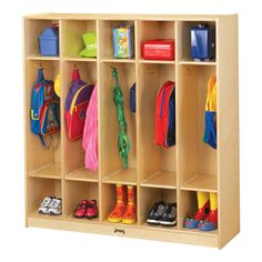 a child's wooden locker with many coats and shoes