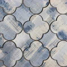 an artistic tile pattern with blue and white colors on the outside, in shades of gray