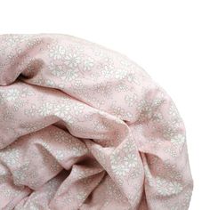 a pink and white flowered fabric on a white background