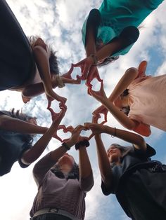 a group of people standing in a circle holding scissors