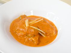 a white bowl filled with food on top of a table