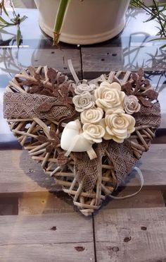 a heart shaped basket with flowers on it