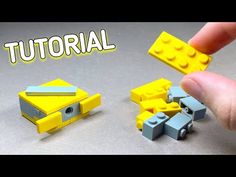 a hand holding a yellow lego block next to a small toy car and another piece that has been made out of legos