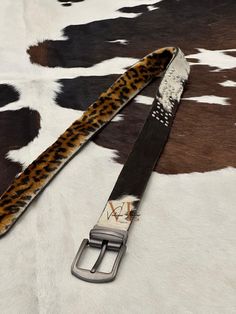 Elevate your wardrobe with our Luxurious Cowhide Belt, a masterpiece of natural craftsmanship and sophisticated style. Handcrafted with care, this belt features authentic cowhide leather, adorned with beautiful, naturally occurring hairs that make each piece uniquely stunning. Key Features: Premium Quality: Made from genuine cowhide leather, ensuring durability and a luxurious feel. Unique Design: Each belt showcases natural variations and beautiful hair patterns, making every belt a one-of-a-ki Fur Belt, Cowhide Belt, Luxe Design, Hair Patterns, Memorable Gifts, Sophisticated Style, Cowhide Leather, Leather Belt, Beautiful Hair