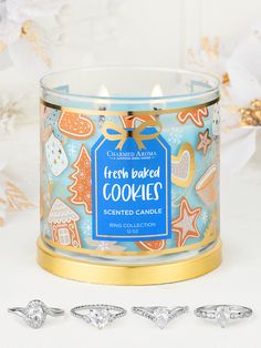 a glass candle with three cookies on it