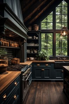 a kitchen with dark blue cabinets and wood flooring is pictured in this image, the light shines through the windows