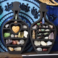 two decorative vases with rocks and stones in them