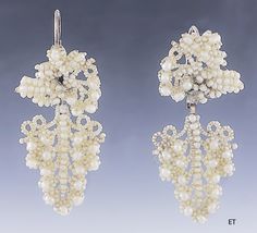 Presented is a lovely pair of Victorian seed pearl bridal earrings. These pieces date to around the 1850-1870 and are of American make. The earrings have 10 karat gold backs, for pierced ears. The earrings consist of seed pearls with larger round pearls sewn onto a mother-of-pearl backing, forming a design of a cluster of grapes. Seed pearl jewelry in this delicate, hand-sewn style was often made and worn specifically as bridal jewelry for a wedding, and this suite would be a lovely addition to Antique Wedding Earrings With Historical Design, Ornate Historical Wedding Earrings, Ornate Historical Design Earrings For Wedding, Victorian Evening Earrings With 17 Jewels, Victorian Pearl Earrings For Wedding, Victorian Pearl Earrings For Anniversary, Victorian Wedding Earrings With 17 Jewels, Victorian Baroque Earrings For Formal Occasions, Victorian Earrings For Evening