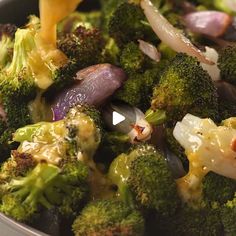 broccoli and onions are being cooked in a skillet with yellow sauce on top