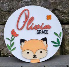 a white sign with a red fox on it's face and the words olvina grace above it