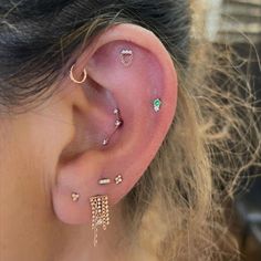 a close up of a person with ear piercings on their ears and behind the ear