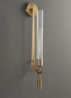 a wall light that is attached to the side of a wall with a glass tube on it