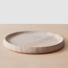 a wooden plate sitting on top of a table