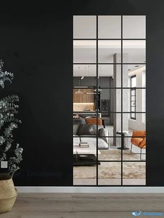 a living room with black walls and glass doors that lead into the dining room area