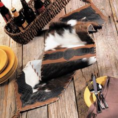 an image of a table setting with place settings and wine bottles on the wooden floor