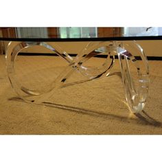 a glass coffee table sitting on top of a carpeted floor