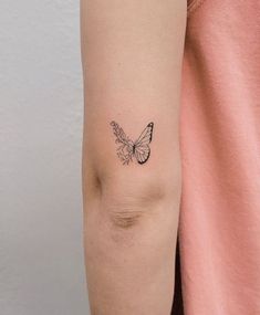 a woman's arm with a butterfly tattoo on the left side of her arm