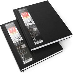 two black notebooks sitting side by side on top of each other in front of a white background