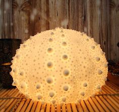 a white lamp sitting on top of a bamboo table