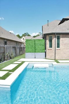 a swimming pool with artificial grass on the side