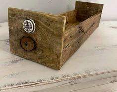 a wooden box sitting on top of a white table