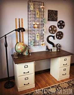 an image of a desk in the middle of a room with lots of items on it