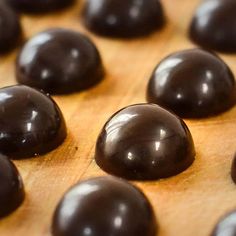 some chocolates are sitting on a wooden surface