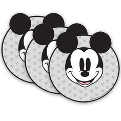 three mickey mouse coasters with black and white designs on them, one has a smiling face